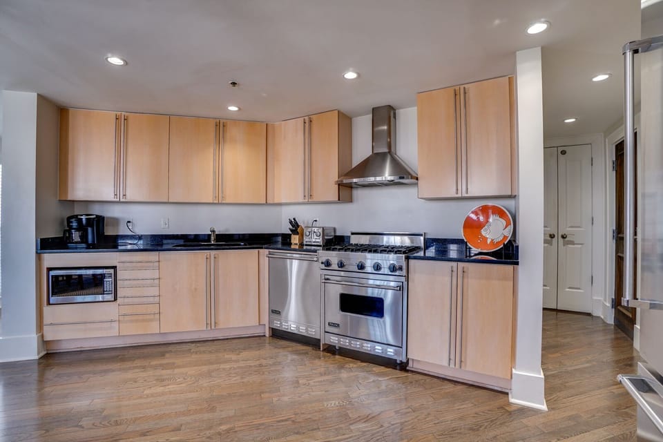 Your spacious modern kitchen awaits with sleek stainless steel appliances, rich wood cabinets, and granite countertops - perfect for preparing memorable meals.