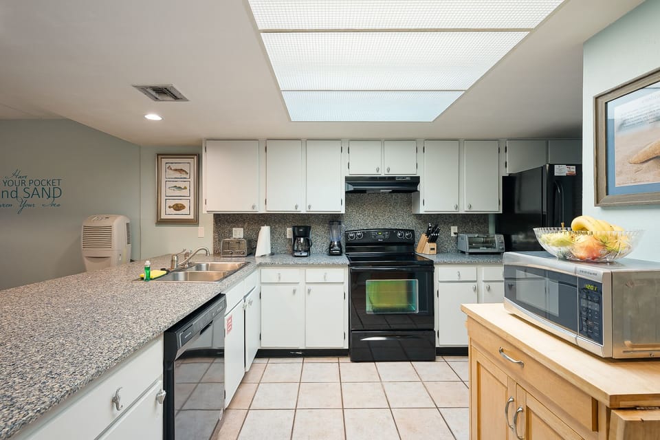 The open kitchen keeps everyone connected while preparing meals and snacks.