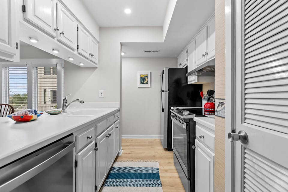 Galley kitchen with stainless steel appliances