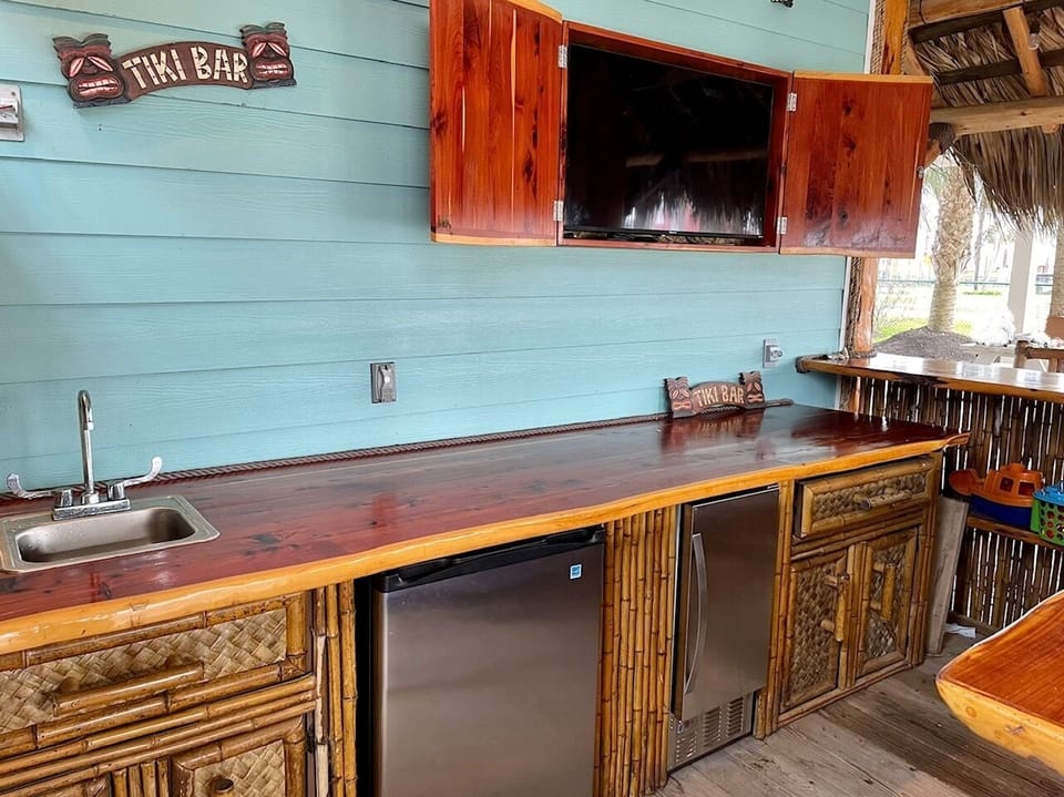 Outdoor entertaining at its finest in the Palapa - mix your drinks at the bar!