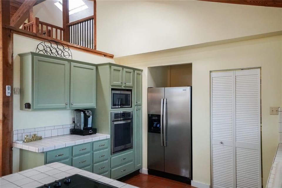Well-appointed kitchen with washer dryer behind the white door