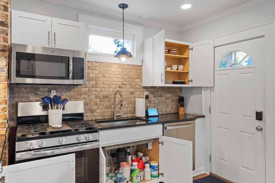 Close up of the Kitchen showing the  cleaning supplies, plates and bowls, knives