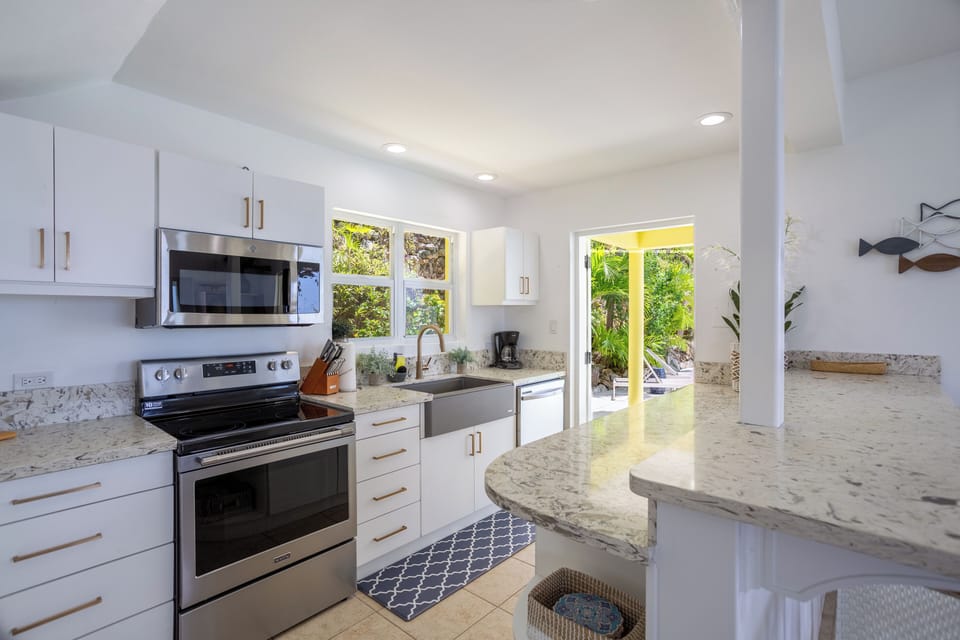 The kitchen has stainless appliances, and is located close to the BBQ outside