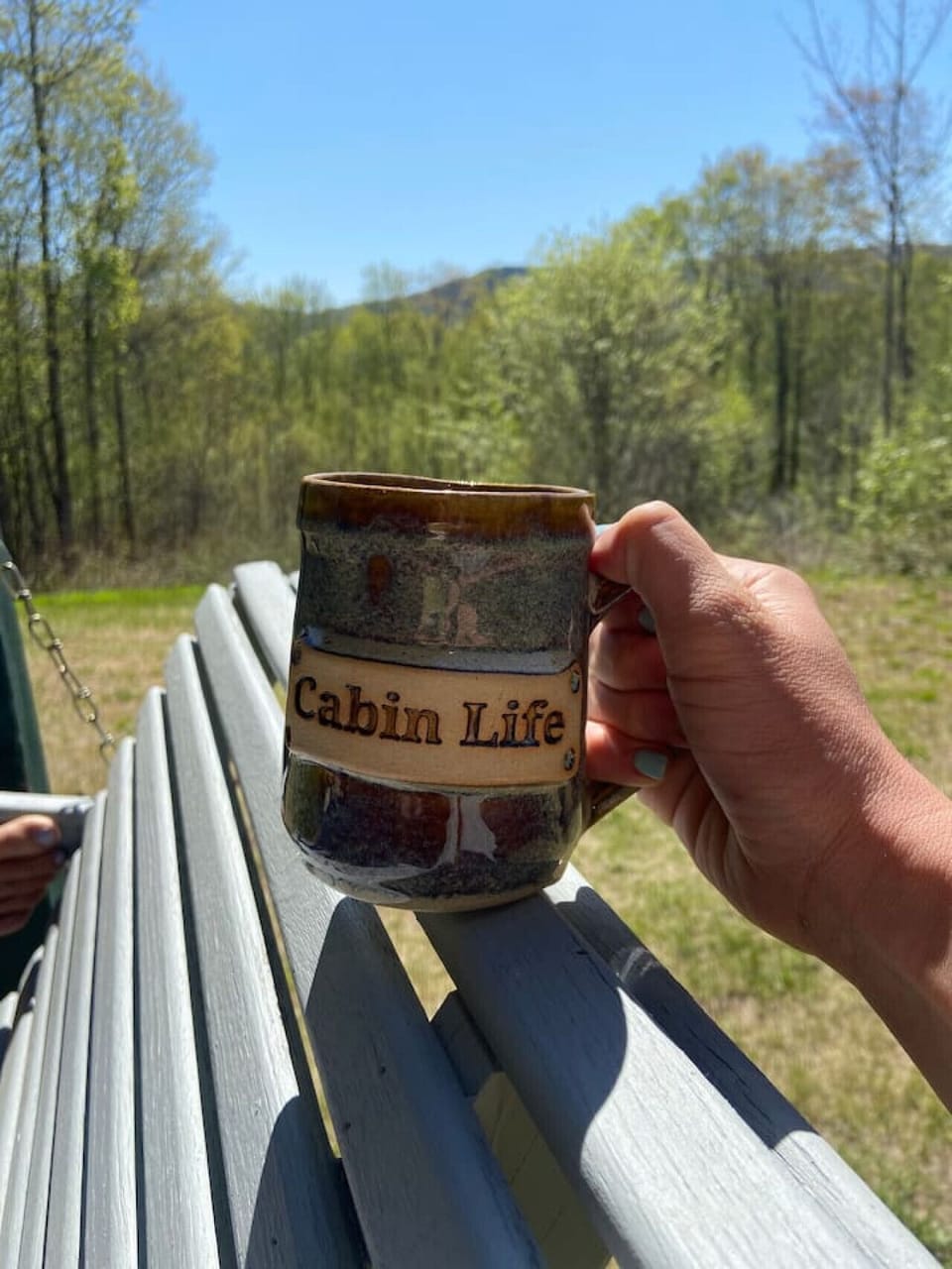 Experience true cabin life — unwind with a coffee and nature all around.