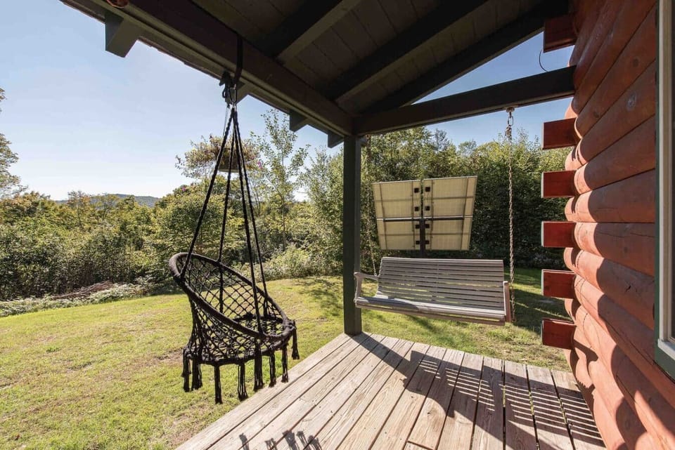 Covered porch with swing and hanging chair — your favorite morning coffee spot.