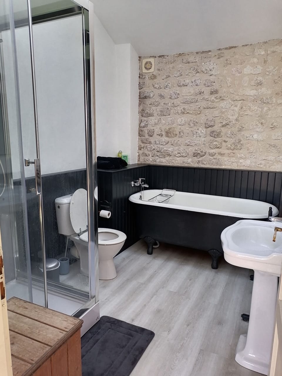 Bathroom with large shower and roll top bath.