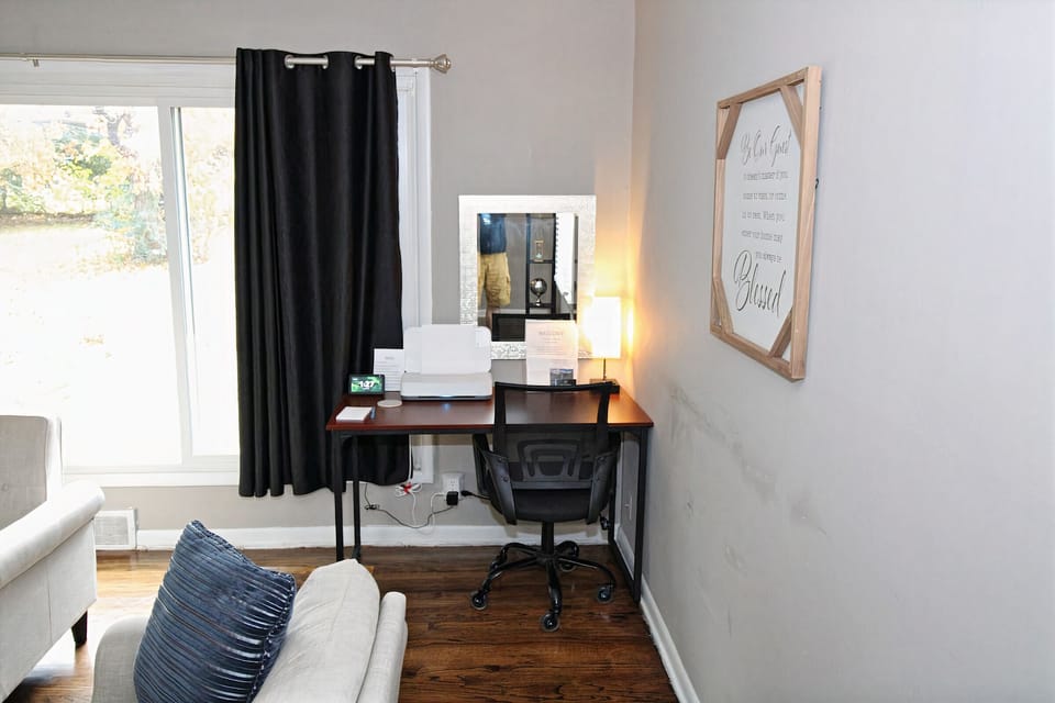 Office desk with printer and a mirror