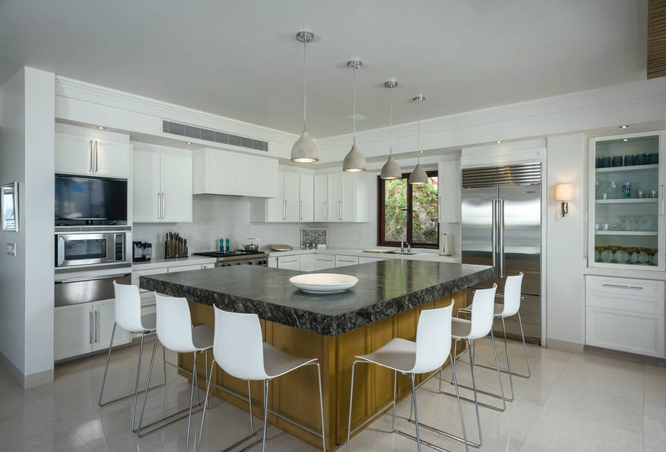 Enjoy a meal at the expansive breakfast bar in the gourmet kitchen of Villa Pacifica
