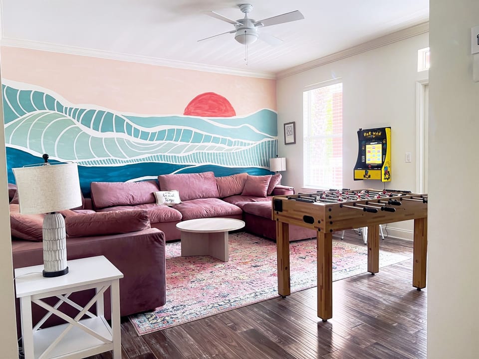 Fun hangout space on second floor with a 65" TV, arcade and foosball table