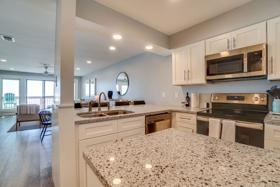 Your spacious kitchen features granite countertops and stainless appliances, perfect for preparing meals while enjoying the open-concept flow to your dining and living areas.