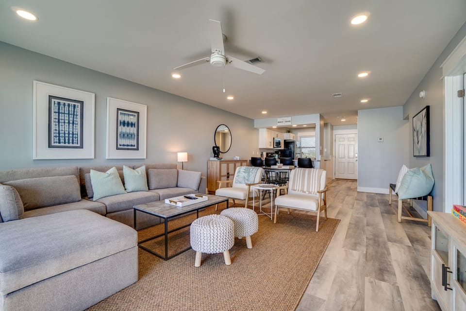 Relax in your bright, modern living space with plush seating and coastal-inspired decor that flows seamlessly into the open kitchen.