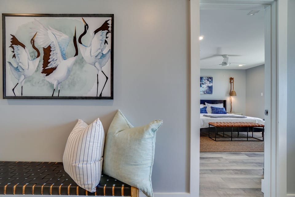 Your thoughtfully designed space welcomes you with elegant crane artwork and soft seating leading to a restful bedroom sanctuary.