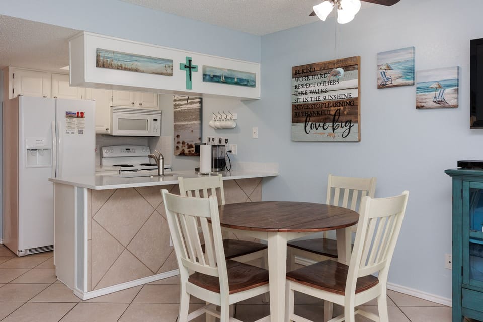 Gather around your charming dining table for morning coffee or evening meals in this coastal-themed space with a fully equipped kitchen.
