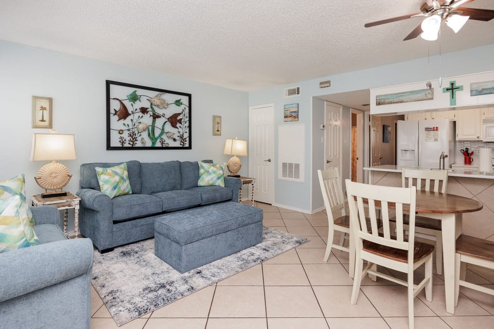 Sink into plush blue seating while coastal artwork and soft lighting create your perfect home-away-from-home retreat.