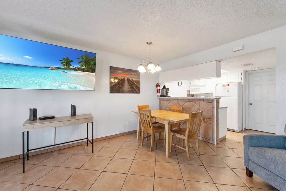 Your bright, open space combines kitchen, dining, and living areas with tropical artwork creating a welcoming home-away-from-home atmosphere.