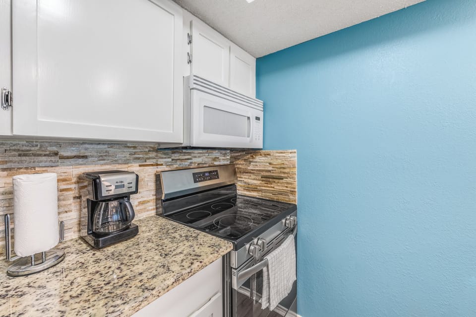 Wake up to fresh coffee from your private kitchen, complete with modern appliances and gorgeous granite counters.