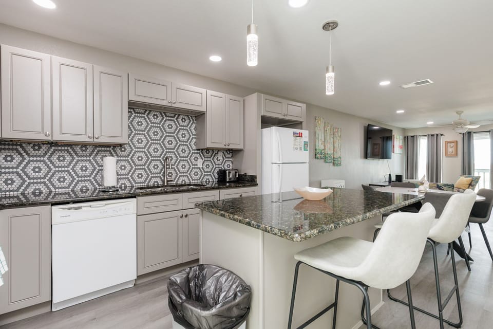 Cook together in your stylish open kitchen, with granite counters and modern bar seating perfect for morning coffee conversations.
