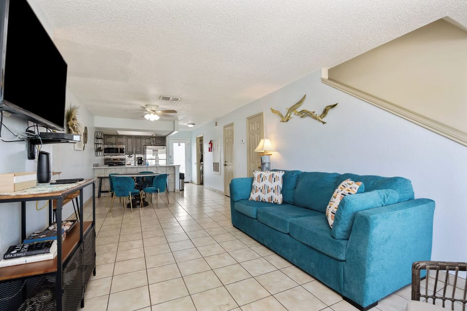 Relax on the vibrant sleeper sofa while enjoying your favorite shows, with the open kitchen and dining space creating a perfect flow for socializing.