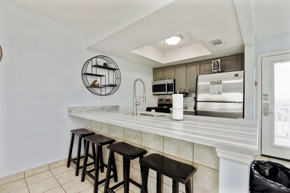 Your fully equipped kitchen features elegant granite counters and modern appliances, perfect for preparing meals or enjoying morning coffee.