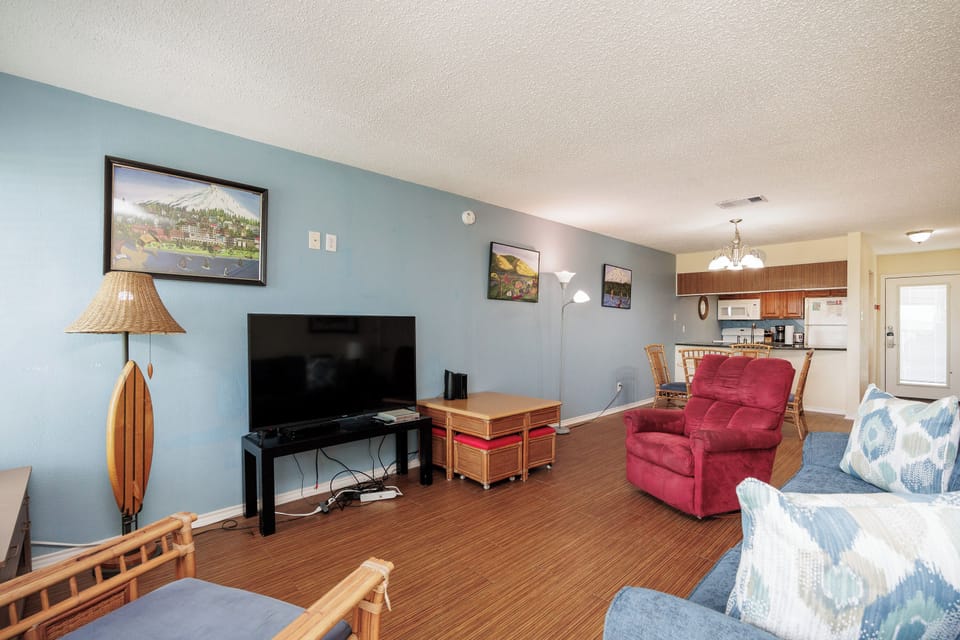 Relax in your spacious living room with plush seating, large TV, and coastal-inspired decor that creates the perfect home base for your getaway.