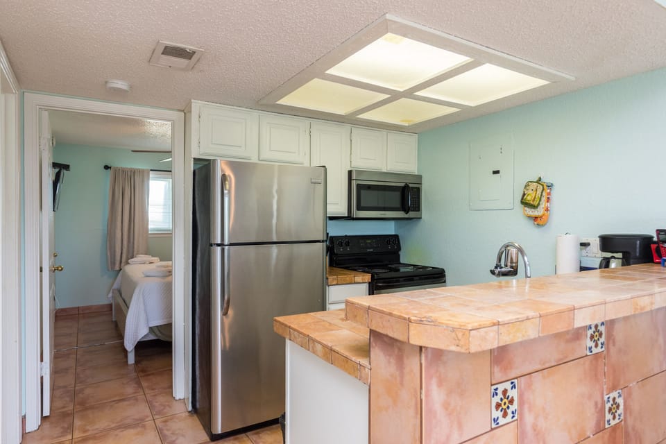 Your fully equipped kitchen features stainless steel appliances and charming tile details, perfect for preparing meals during your stay.