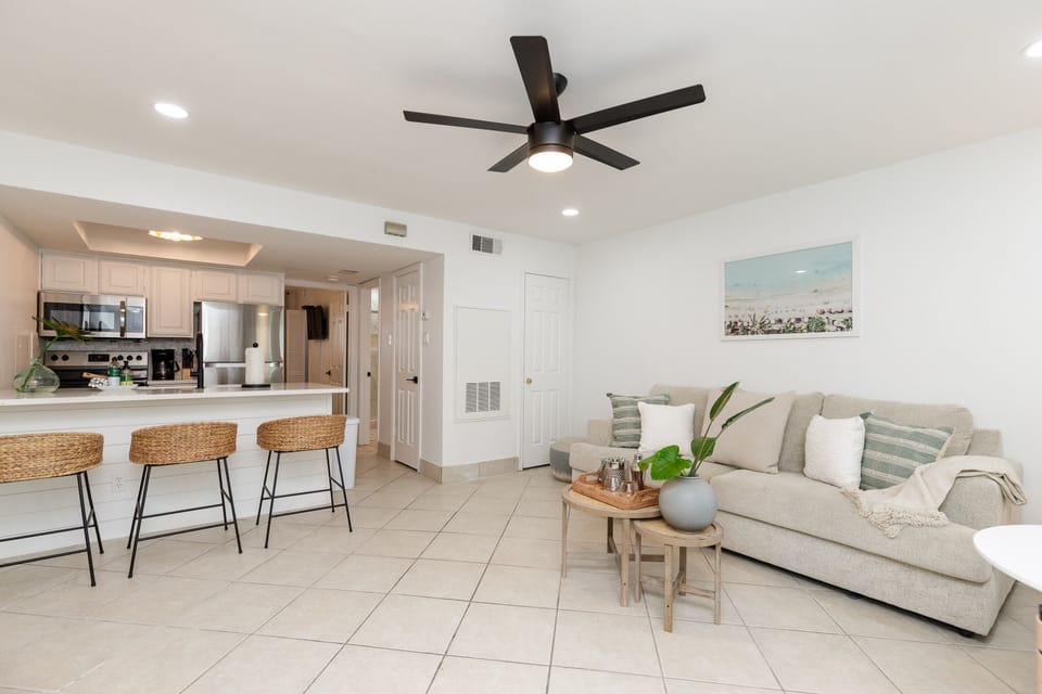Relax in your bright, modern living space with coastal touches and a fully equipped kitchen perfect for preparing meals during your stay.