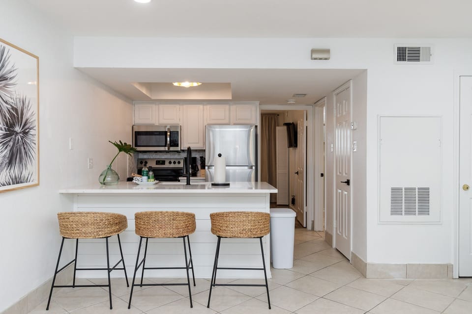 Your bright, modern kitchen features sleek appliances and a welcoming breakfast bar where you can enjoy morning coffee or casual meals.