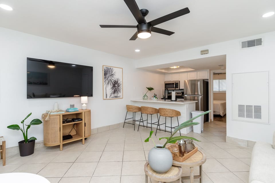 Relax in your bright, modern living space with coastal-inspired décor, full kitchen, and stylish furnishings for perfect vacation comfort.