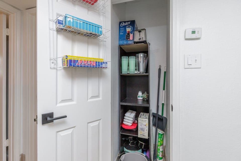 Your organized utility closet keeps essentials tidy, with cleaning supplies and household items perfectly arranged for convenience.