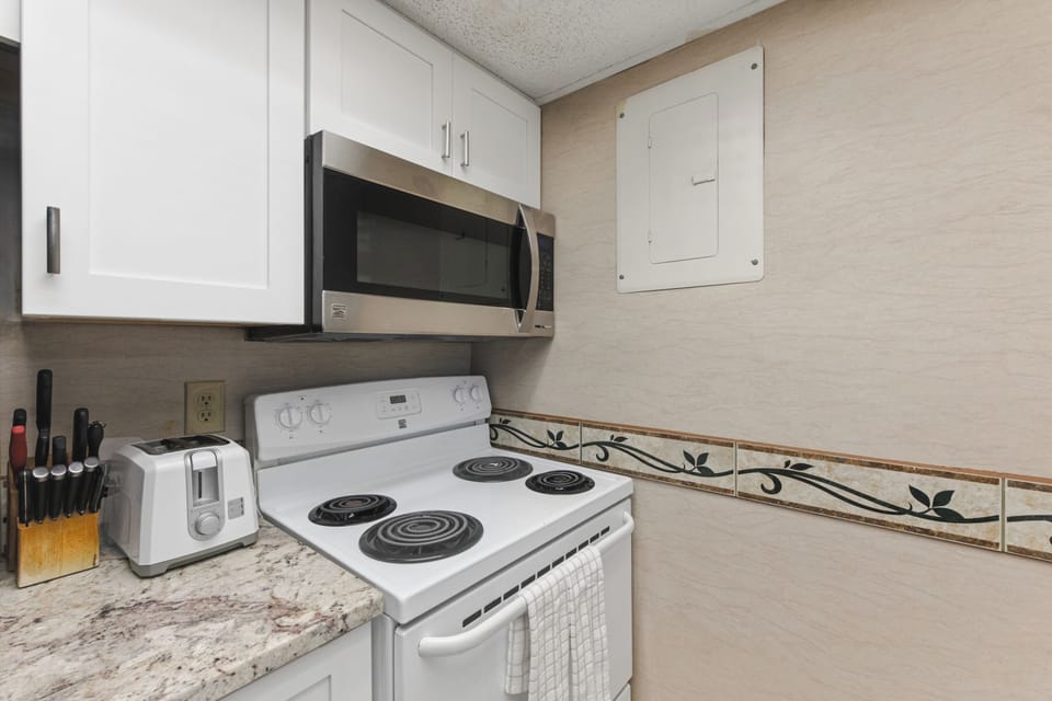 Your fully equipped kitchen awaits with modern appliances and granite counters, perfect for preparing memorable meals during your stay.