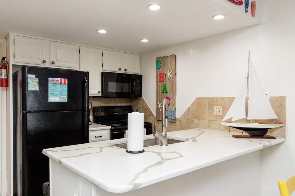 Your beachside kitchen awaits with modern appliances and coastal charm, perfect for preparing meals during your getaway.