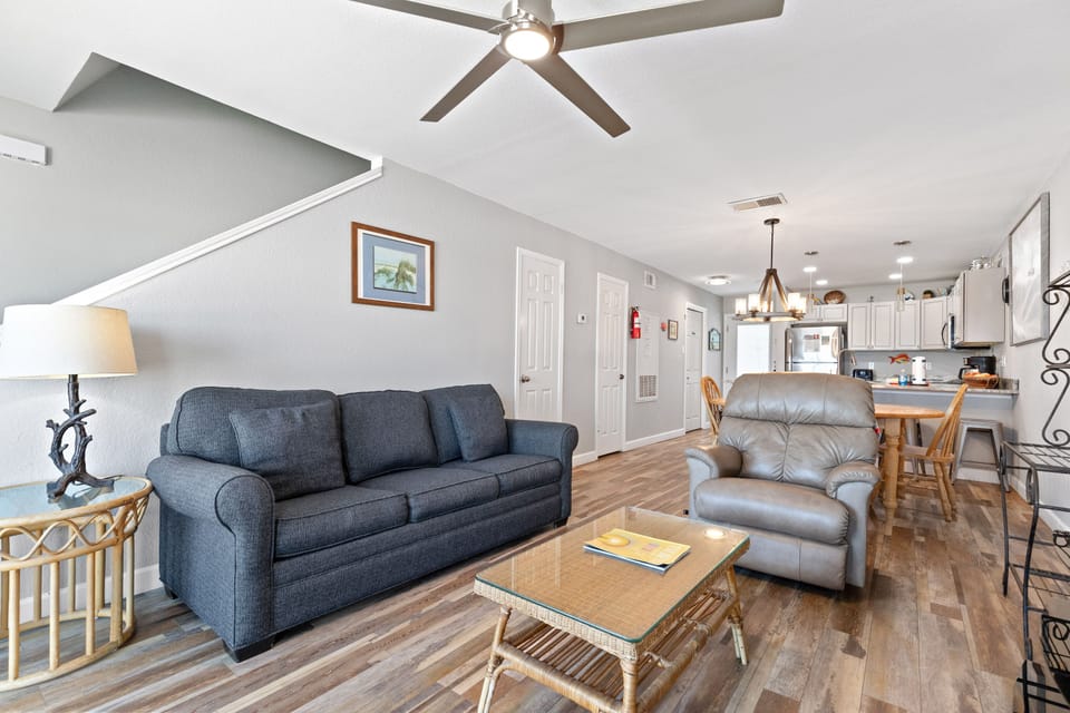 Settle into your spacious open-concept living area with comfy seating, modern kitchen, and warm wood floors perfect for relaxing after your adventures.