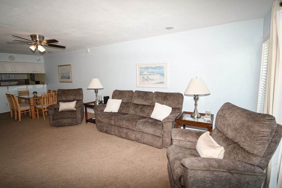 Relax in your spacious living room with plush seating, soft lighting, and an open layout connecting to your fully equipped kitchen.