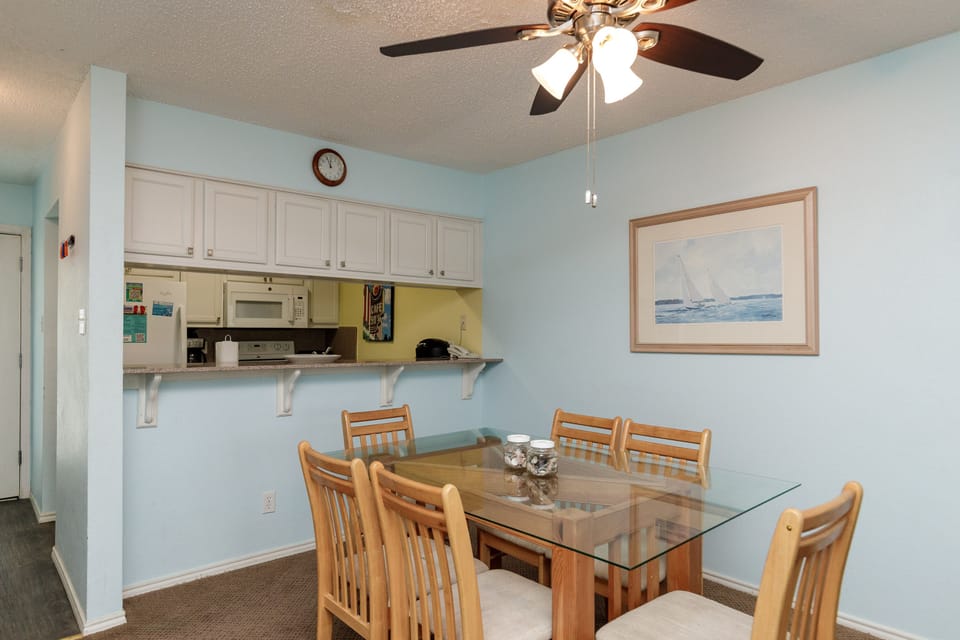 Gather around your glass dining table for meals and games, with the convenience of a fully equipped kitchen just steps away.