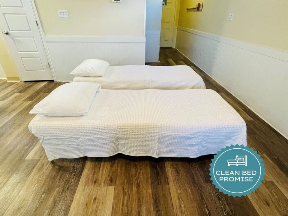 Drift off to sleep on these comfortable twin beds with fresh linens and pillows in your bright, welcoming room.
