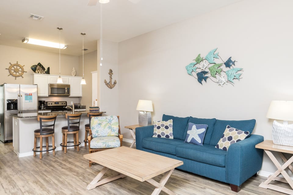 Your coastal-themed living space features nautical décor and an open kitchen, perfect for relaxing after beach adventures.