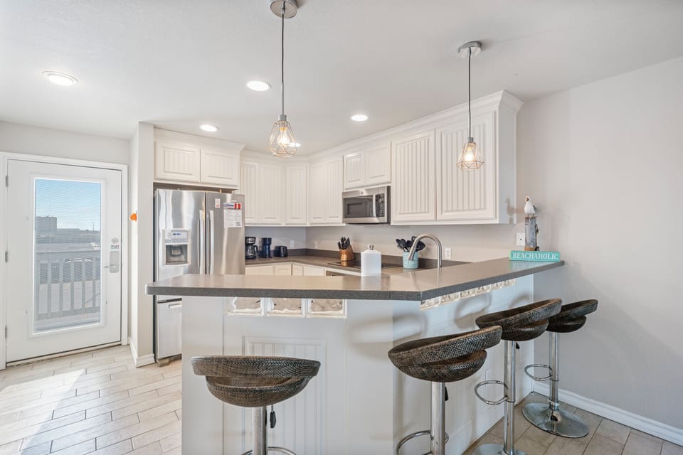 Cook memorable meals in your bright, fully-equipped kitchen with granite countertops, stainless appliances, and breakfast bar seating for casual dining.
