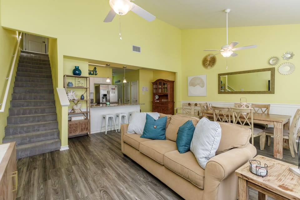 Relax in your open-plan living space with comfortable seating, full kitchen access, and coastal decor that makes you feel right at home.