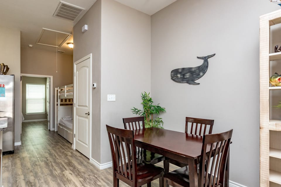 Gather around your cozy dining table for memorable meals with loved ones in this thoughtfully designed space.