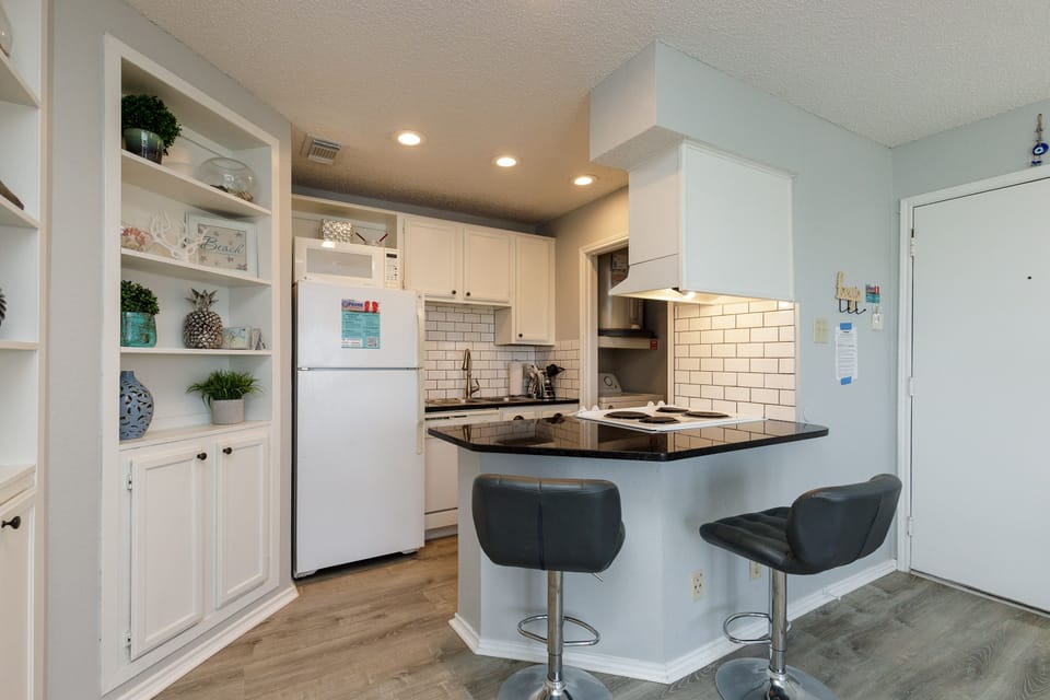 Your fully equipped kitchen features granite counters, breakfast bar seating, and everything needed for cooking memorable meals.