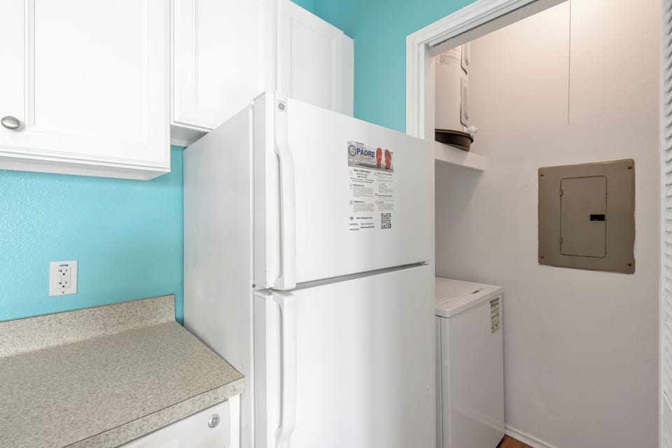 Your fully equipped kitchen features a spacious refrigerator and convenient in-unit washer and dryer for ultimate comfort.