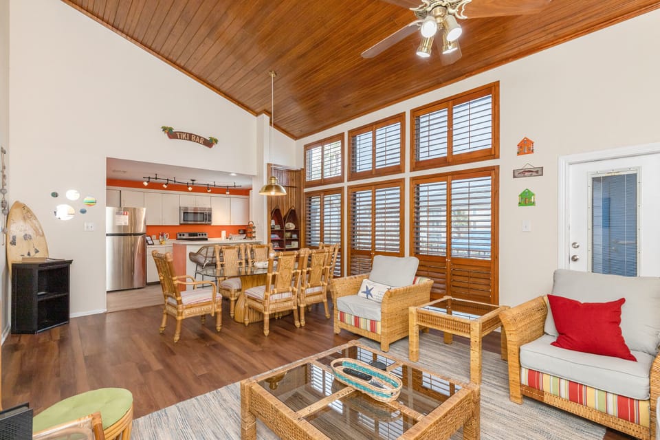 Spacious living area with pool and water views from the large windows.