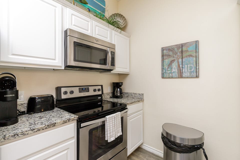 Your fully equipped kitchen features granite counters, stainless steel appliances, and a coffee station for convenient meal prep.