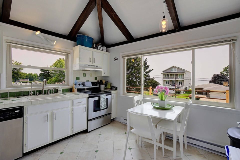 Back inside, the sunny eat-in kitchen on the main floor looks out over the deck to the Chesapeake Bay.
