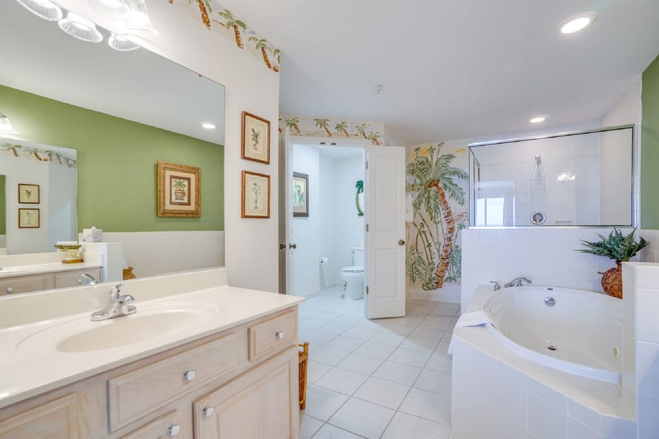 Unwind in your spacious master bathroom with a luxurious jetted tub and tropical palm murals that transport you to paradise.