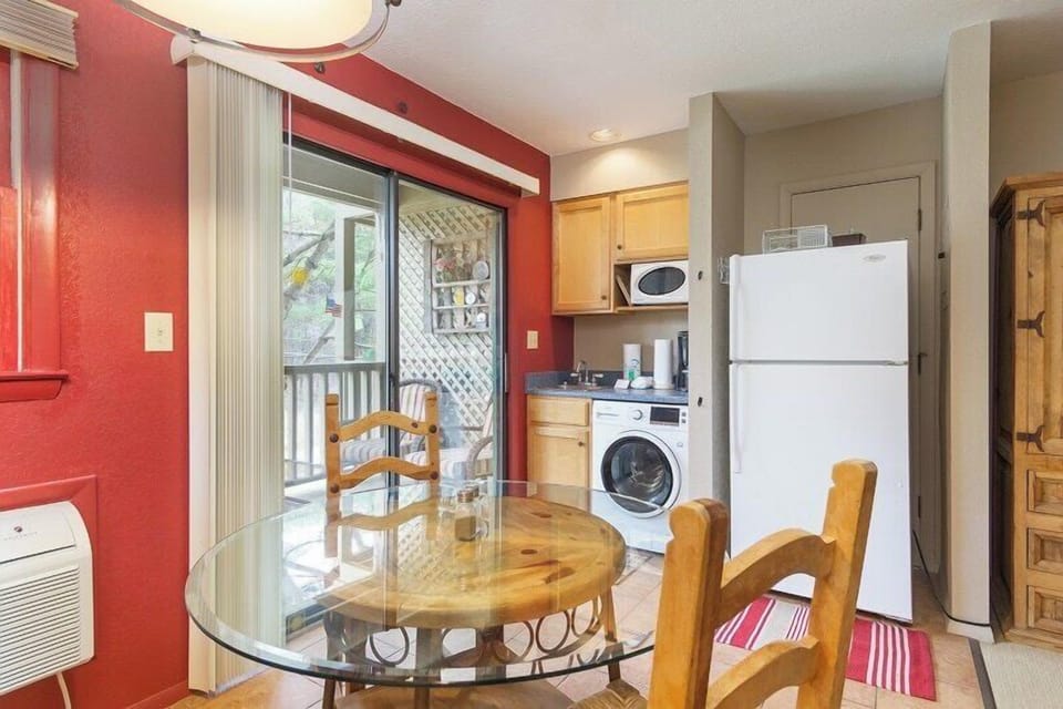 Enjoy meals at the cozy dining table. Kitchenette includes an apartment sized fridge, microwave, toaster oven, and griddle. Unit does not have an oven or cooktop