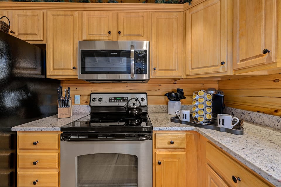 Fully stocked kitchen, including a Keurig, a coffee pot, and a tea kettle.