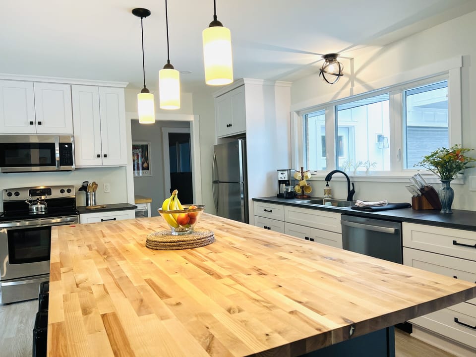 Spacious and fully equipped kitchen with large butcher block island.