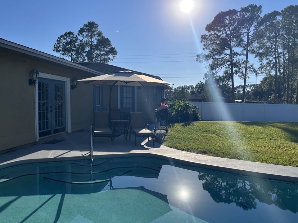 Sunny private pool with outdoor dining—great for relaxing after Crescent Beach.