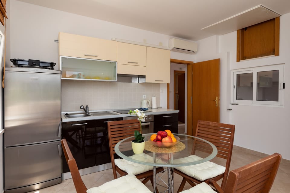 Apartment (Two Bedroom Apartment with Terrace) | Private kitchen | Fridge, stovetop, electric kettle, highchair